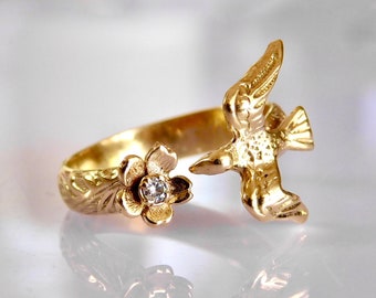 Bird kissing a flower diamond ring in solid gold