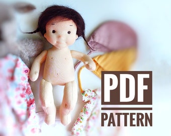 May include: A PDF pattern for a handmade doll. The doll is made of fabric and has a light brown complexion, black hair, and brown eyes. The doll is wearing a white dress with a floral pattern.
