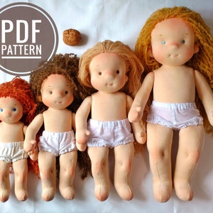 May include: Four handmade cloth dolls of varying sizes, with blonde and red hair, wearing white undergarments. The dolls are arranged in a row from smallest to largest on a white surface. The dolls have painted eyes and rosy cheeks.