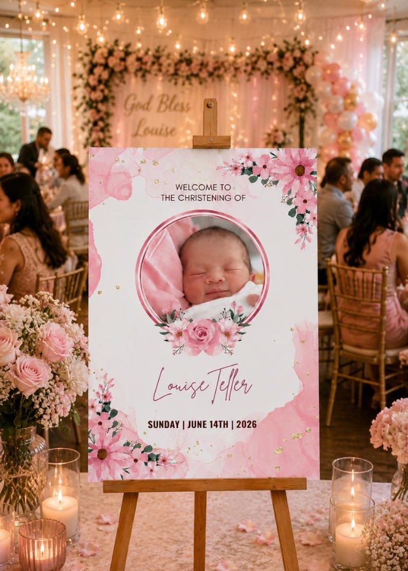 May include: A wooden easel displays a pink and white sign for a christening. The sign features a baby's photo, floral accents, and the text "Welcome to the Christening of Louise Teller, Sunday, June 14th, 2026."