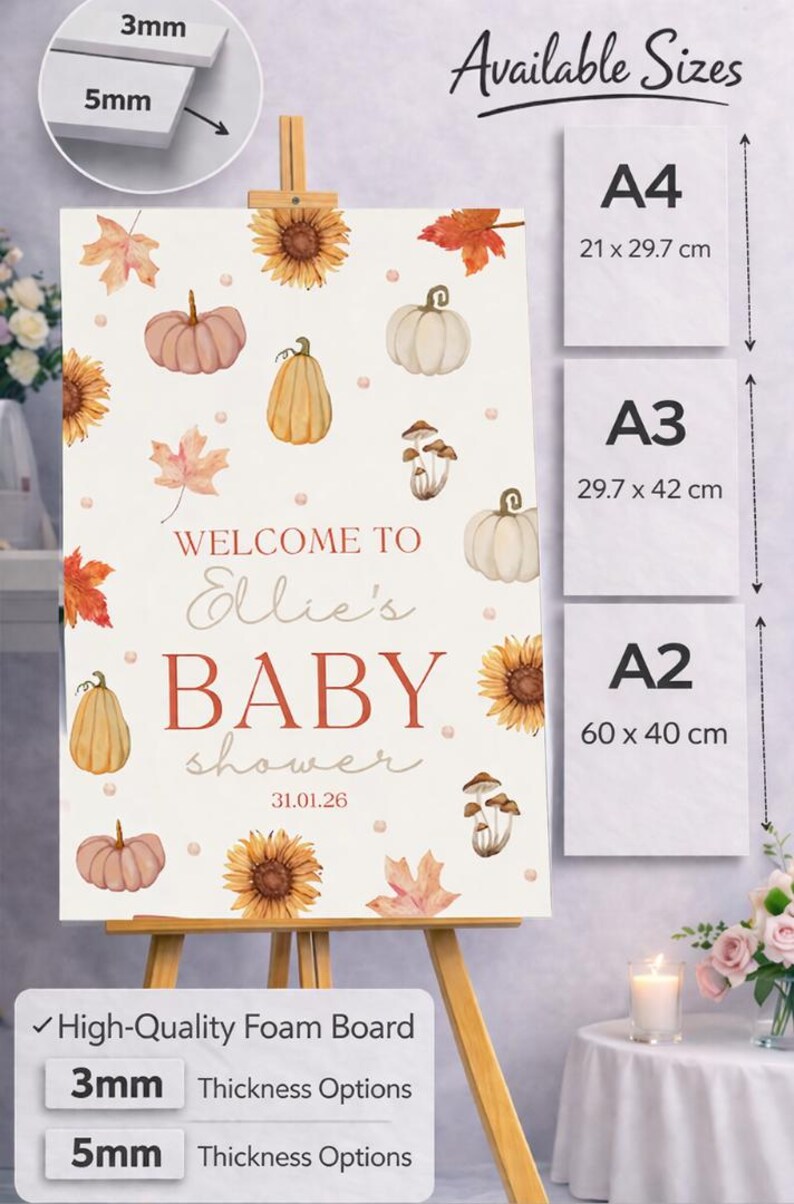 May include: A baby shower sign on an easel, featuring watercolor illustrations of pumpkins, sunflowers, and leaves. The sign reads "Welcome to Ellie's Baby Shower" with the date 31.01.26. Available sizes are A4 (8.3 x 11.7 inches), A3 (11.7 x 16.5 inches), and A2 (23.6 x 15.7 inches).