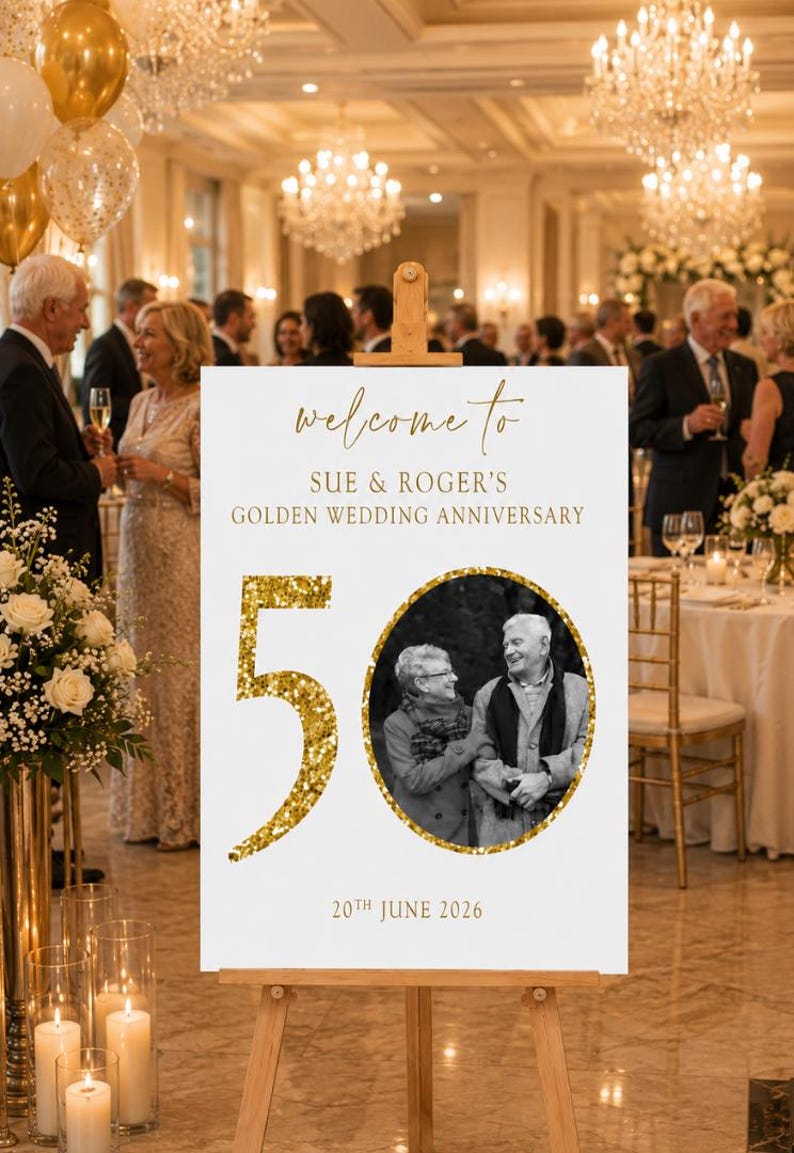 May include: A white sign on a wooden easel with gold text that reads "welcome to SUE & ROGER'S GOLDEN WEDDING ANNIVERSARY". A gold glitter "50" and a black and white photo of a couple are featured. The date "20th JUNE 2026" is also displayed.