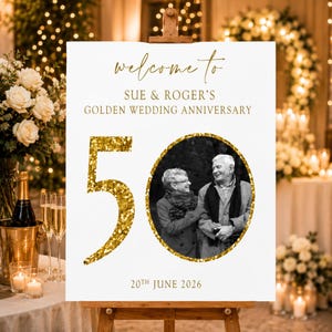 May include: A white sign on a wooden easel with gold text that reads "welcome to Sue & Roger's Golden Wedding Anniversary." A gold glitter "50" is next to a black and white photo of a couple. The date "20th June 2026" is at the bottom.