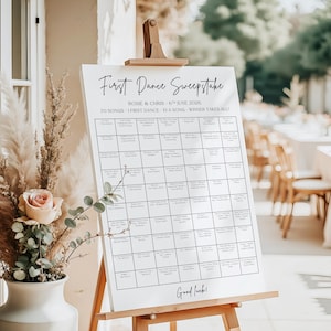 May include: A white sign on a wooden easel with the text "First Dance Sweepstake". The sign includes the names "Rosie & Chris", the date "6th June 2026", and the phrase "70 Songs - 1 First Dance - EIA Song - Winner Takes All!"
