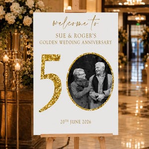May include: A white sign on a wooden easel with gold text that reads "Welcome to Sue & Roger's Golden Wedding Anniversary." A photo of a couple is in a gold circle, with a large gold glitter "50" and the date "20th June 2026".