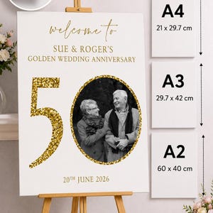 May include: A white foam board sign for a golden wedding anniversary, featuring the text "welcome to" and "SUE & ROGER'S GOLDEN WEDDING ANNIVERSARY". The number "50" is in gold glitter. Available sizes are A4 (8.3 x 11.7 inches), A3 (11.7 x 16.5 inches), and A2 (23.6 x 15.7 inches).
