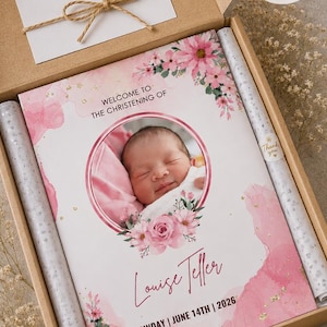 May include: A christening gift box featuring a baby's photo and name, with a card that says "Thank you". The main card reads "Welcome to the Christening of Louise Teller, Sunday, June 14th, 2026". The box is A4 size and includes decorative elements.