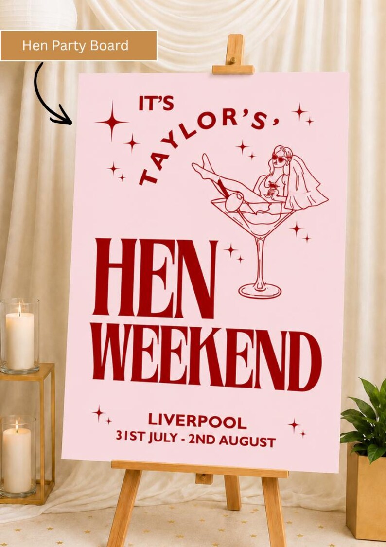 May include: A pink Hen Weekend sign on an easel. The sign has the text "IT'S TAYLOR'S, HEN WEEKEND, LIVERPOOL 31ST JULY - 2ND AUGUST" in burgundy. A drawing of a woman in a martini glass is also on the sign.