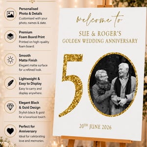 May include: A white sign on a wooden easel, celebrating a golden wedding anniversary. The sign reads "Welcome to Sue & Roger's Golden Wedding Anniversary" with a photo of the couple and the number "50" in gold glitter. The date "20th June 2026" is also displayed.
