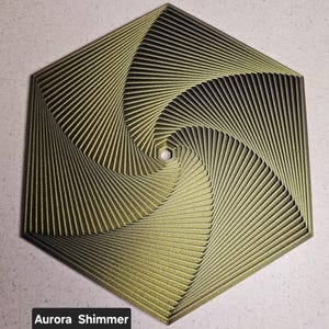 May include: A hexagonal, gold-colored, geometric wall art piece with a swirling pattern. The piece has a textured, shimmery finish.