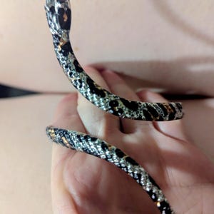 May include: A set of three ceramic mugs with a speckled, matte finish. The mugs are in shades of cream, light gray, and dark gray. Each mug has a simple, minimalist design, perfect for coffee or tea.