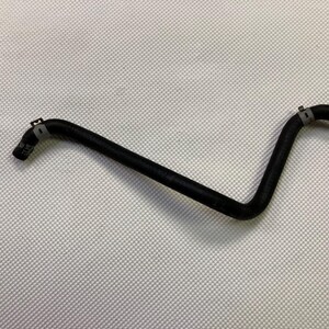 May include: A black rubber hose with two metal clamps. The hose is bent in the middle, creating a V-shape.