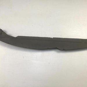 May include: A dark gray, curved, elongated object with a rough texture. The object has a slightly irregular shape, with a thicker, rounded end and a thinner, tapered end. It appears to be made of a dense material.