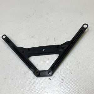 May include: A black metal bracket with a V-shape design. The bracket has two holes at the ends of the V and a triangular opening in the center. It appears to be a component of a larger assembly.