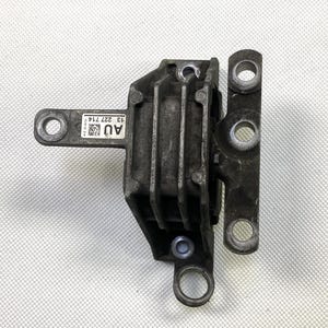 May include: A black metal engine mount with a rectangular shape and multiple holes. The mount has a label that reads "AU 13 227 774".