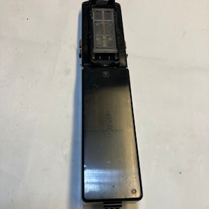 May include: A black rectangular electronic component with a clear plastic insert on top. The component has a label that reads "ABS+PC".
