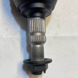 May include: A black metal automotive axle shaft with a silver threaded end and a black metal flange.