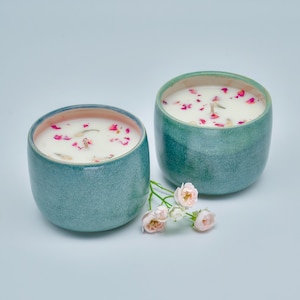 Scented organic soy candles decorated with flowers in a unique handmade ceramic containers