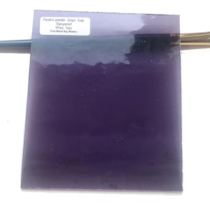 May include: A sheet of purple-lavender grape soda glass, transparent, with the text "Purple Lavender Grape Soda Transparent Tiffany Today From Mixed Bag Mosaics" printed on a white label.