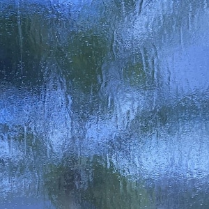 May include: Abstract image with a textured, rippled surface. The dominant color is a deep blue, with hints of green and darker shades suggesting depth and a natural, water-like effect. The overall impression is one of fluidity and movement.
