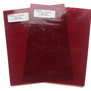 May include: Three sheets of red glass, labeled "Red 0 Black Cherry Transparent Tiffany Taley From Mixed Bag Mosaic".