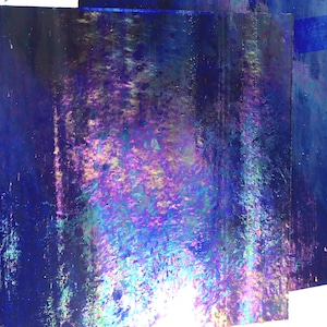 May include: A sheet of iridescent blue glass with a textured surface. The glass has a rainbow sheen with shades of purple, pink, and green.