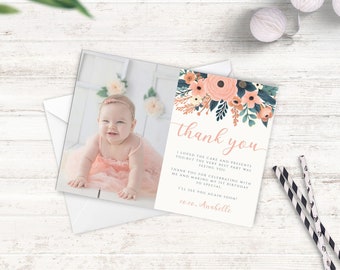 May include: A pink and white floral thank you card with a photo of a baby girl in a pink dress. The text on the card reads "thank you" and "I loved the cake and presents too, but the very best part was seeing you. Thank you for celebrating with me and making my 1st birthday so special. I'll see you again soon! xoxo, Anabelle."