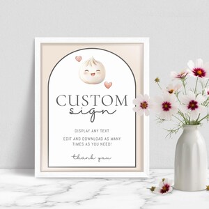 May include: A framed sign with the words "CUSTOM sign" in a script font. The sign features a cartoon dumpling with hearts and the text "DISPLAY ANY TEXT, EDIT AND DOWNLOAD AS MANY TIMES AS YOU NEED! thank you."