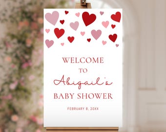 May include: Welcome to Abigail's Baby Shower sign with red and pink hearts on a white background. The date February 8, 20XX is printed at the bottom.
