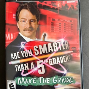 May include: A PlayStation 2 video game case for "Are You Smarter Than a 5th Grader?" features a man with glasses and a mustache. The game title is written with a pencil and apple graphic. The case has an "E" rating.