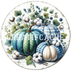 May include: Circular wooden sign with a watercolour illustration of pumpkins, cotton, and foliage. The pumpkins are in shades of blue, green, and white, some with a gingham pattern. The sign has the text "CREATIFCACHE" in white.