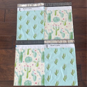 May include: Four poly mailers with a cactus pattern. The mailers are blue and white with a watercolor cactus design. The text "#SmileMail™ by UpShip" is printed on the top of each mailer.