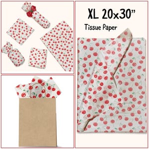 May include: XL 20x30 inch tissue paper with a repeating pattern of red cherries on a white background. Several sheets are shown, some folded and tied with ribbon, and in a brown paper bag.