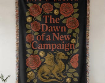 Può includere: Arazzo nero tessuto con un disegno con rose rosse, un drago dorato e il testo "The Dawn of a New Campaign". L'arazzo ha un bordo con frange ed è appeso a una parete.