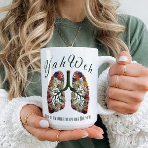 May include: White ceramic mug with a floral design of lungs and the text "Yah Weh Your Very Breath Speaks His Name".