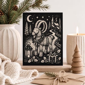 May include: A black and white rectangular greeting card featuring a stylized illustration of a straw goat adorned with a wreath, standing near a lantern, a wrapped gift, a winding path, a small village, and a crescent moon in the night sky.