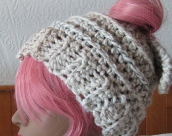 Hand crocheted pony tail/bun hat in heavy weight ivory yarn .  Fun to wear!  Acrylic yarn for easy care.