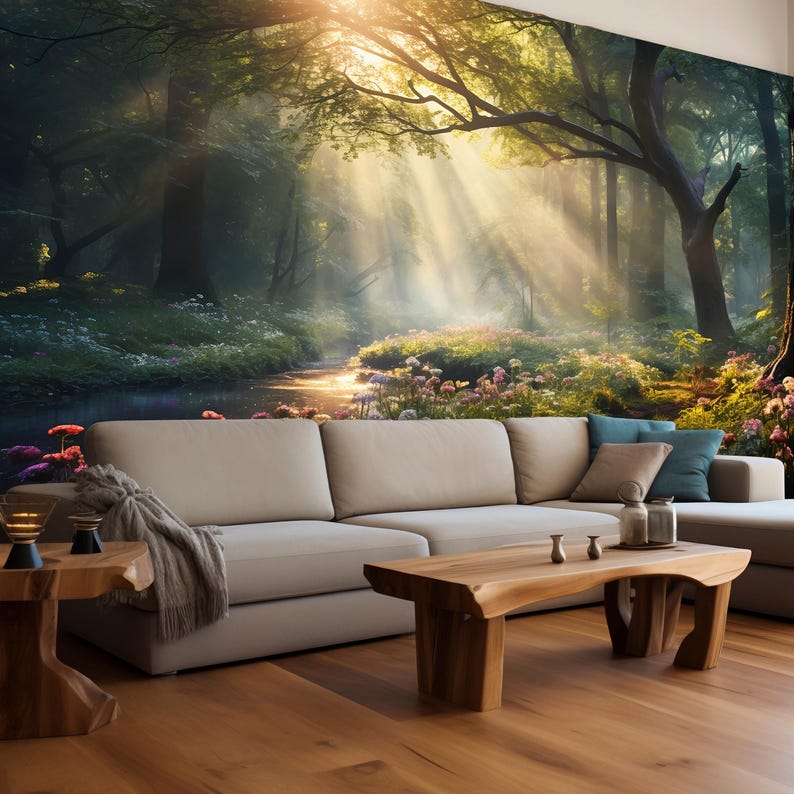 May include: A living room with a large sectional sofa, wooden coffee table, and side table. The focal point is a wall mural depicting a sunlit forest scene with a stream. The room has hardwood floors and is decorated with pillows and a throw blanket.