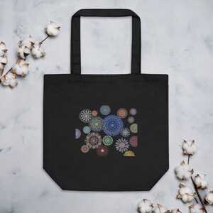 May include: Black tote bag with a design of colorful mandalas on the front.