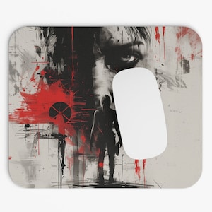 May include: A black and white mouse pad with a red and black abstract design. The design features a person's face and a silhouette of a person holding a weapon. The mouse pad is rectangular and has a smooth surface.