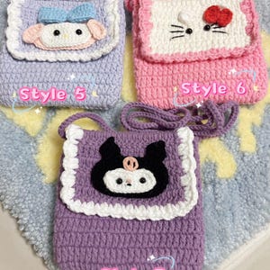 May include: Three crocheted purses with different character designs. The first purse is lavender with a white trim and a light blue and white character with a bow. The second purse is pink with a white trim and a white character with black eyes and a red bow. The third purse is purple with a white trim and a black character with white eyes and a pink nose. Each purse has a strap and the text "Style 5", "Style 6", and "Style 7" is written below each purse.