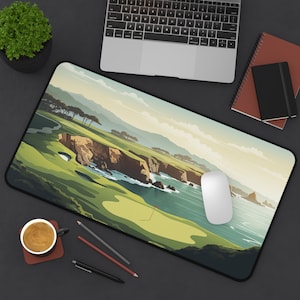 May include: A rectangular desk mouse pad featuring a golf course scene with green fairways, cliffs, and ocean. The design includes a red flag on the green. A white mouse, laptop, and other office supplies are on a dark surface.