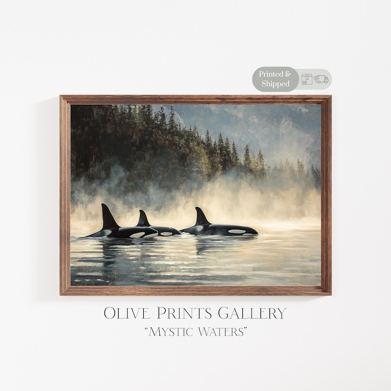May include: A framed print of a painting depicting three orcas swimming in a misty, foggy lake. The orcas are black and white, and the background is a soft, muted blue and green. The print is titled "Mystic Waters".