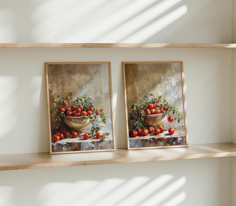 May include: Two framed paintings of still life arrangements featuring bowls overflowing with red tomatoes and green leaves against a beige background.