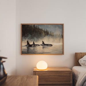 May include: A framed print of three orcas swimming in a misty lake with a forest in the background.