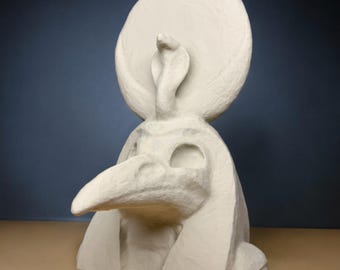 May include: White painted sculpture of the Egyptian god Thoth, depicted with a human body, a bird's head, and a snake on his head.