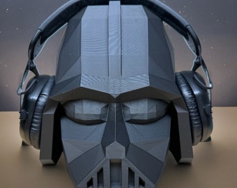 May include: A black and gray Darth Vader-inspired headphone design with a geometric face and large earcups.