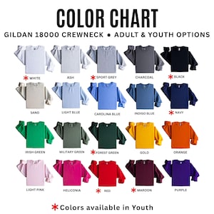 May include: Color chart showcasing Gildan 18000 crewneck sweatshirts in various colors. The image displays a range of options, including white, ash, sport grey, charcoal, and black. Additional colors include sand, light blue, Carolina blue, and indigo blue.