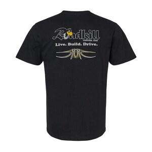 May include: A black short-sleeve t-shirt featuring the white text Roadkill customs.com and the phrase Live. Build. Drive. in white. Below the text is a decorative pinstripe graphic in white and yellow lines on the back of the shirt.