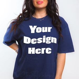 May include: A navy blue oversized t-shirt with the text "Your Design Here" printed in white on the front.